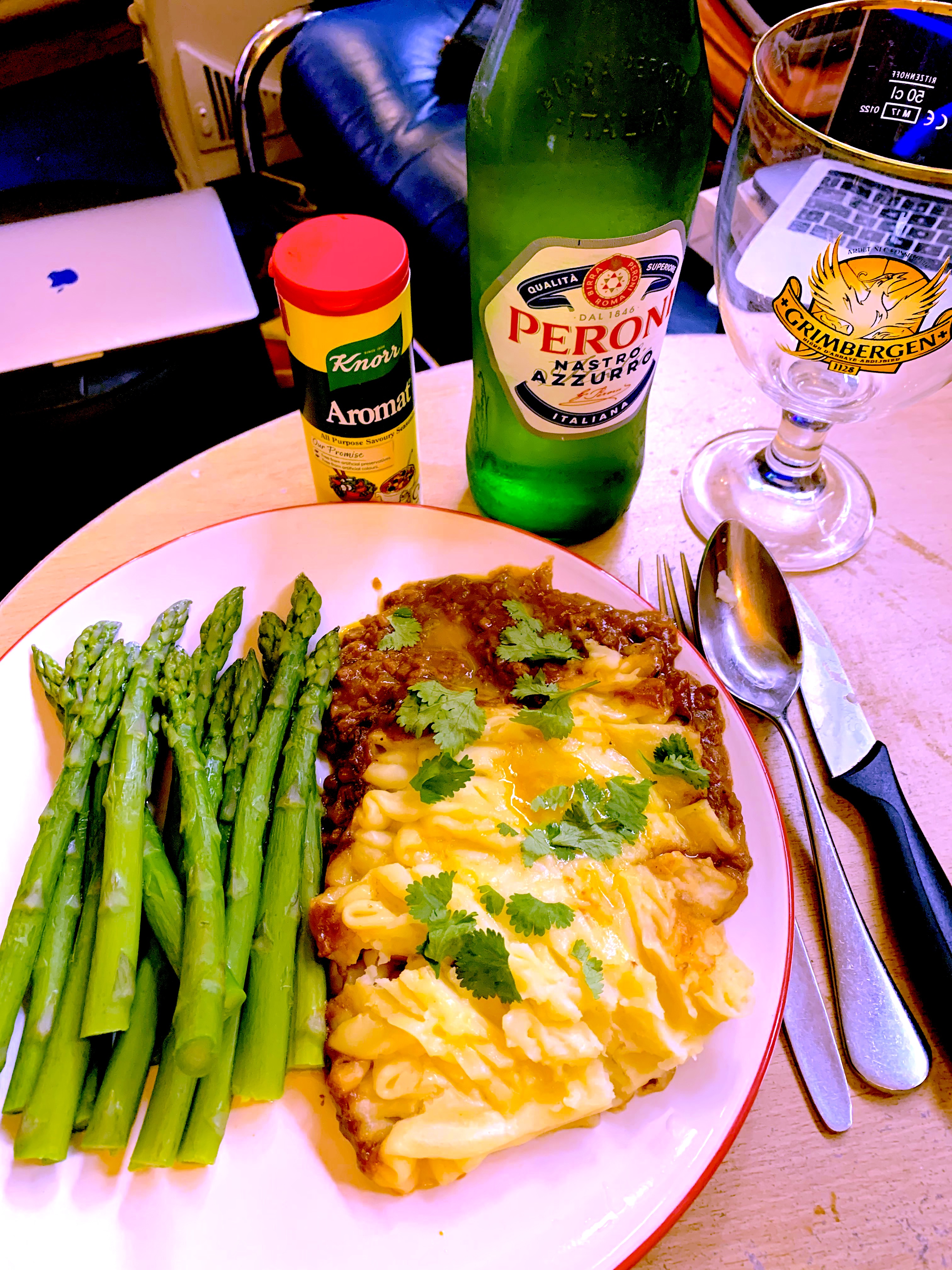 A Cottage pie with asparagus.