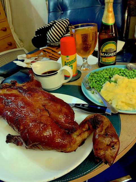 A chinese duck with mash and peas.