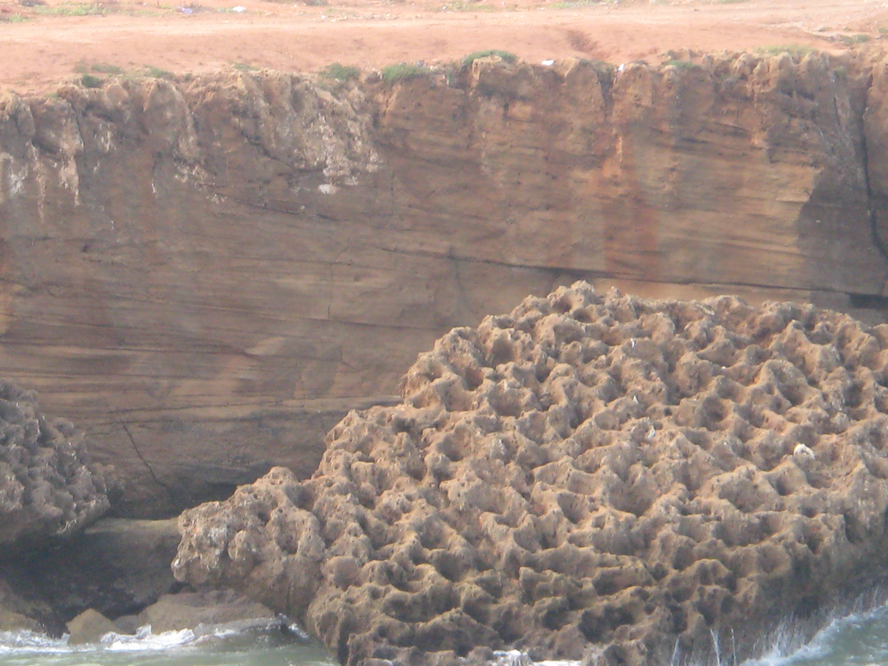 Holes pitted by salt water in solid stone